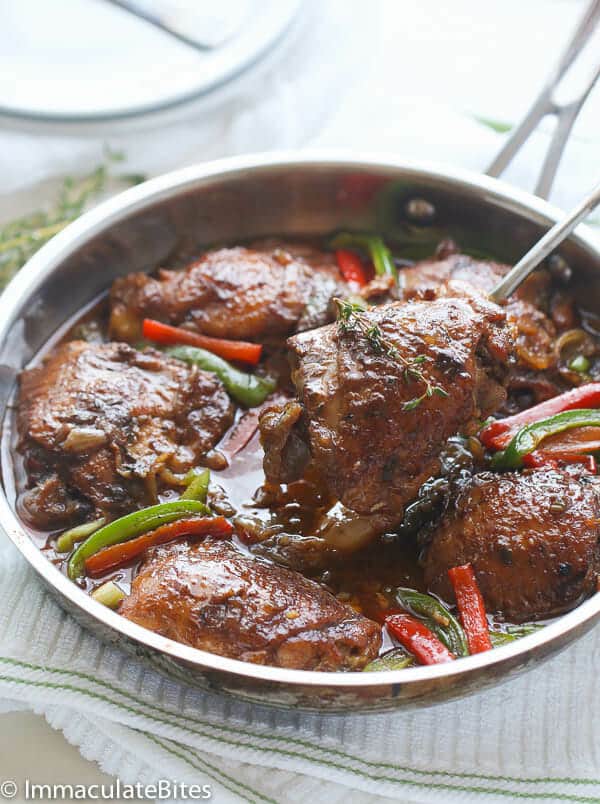 a skillet of Jamaican brown stew chicken