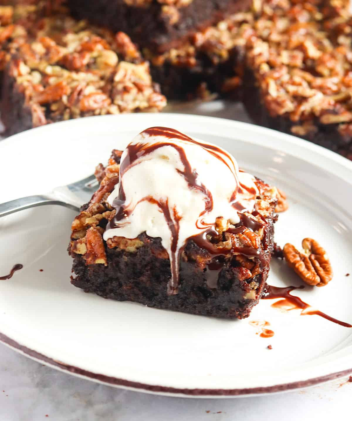 A pecan pie brownie squared topped with ice cream and chocolate sauce. Yum!