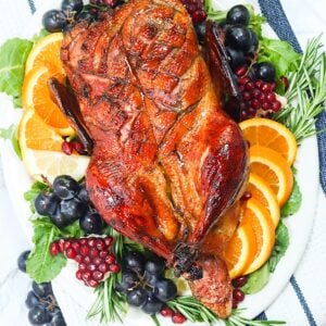 Whole Roast Duck on a gorgeous platter with grapes and orange slices