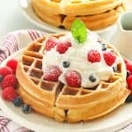 Homemade Waffles topped with whipped cream and berries