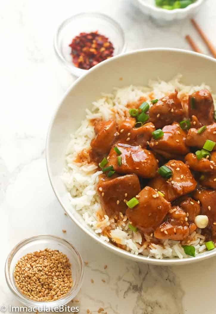 Enjoying a serving of bourbon chicken over white rice