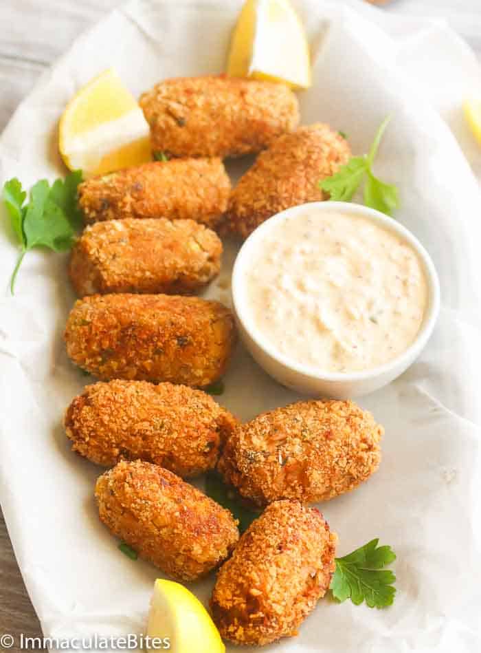 Salmon Croquettes on a platter with remoulade sauce