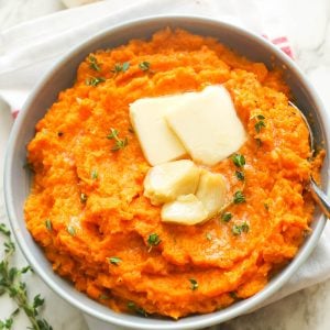 Mashed Sweet Potatoes Topped with Butter and Roasted Garlic