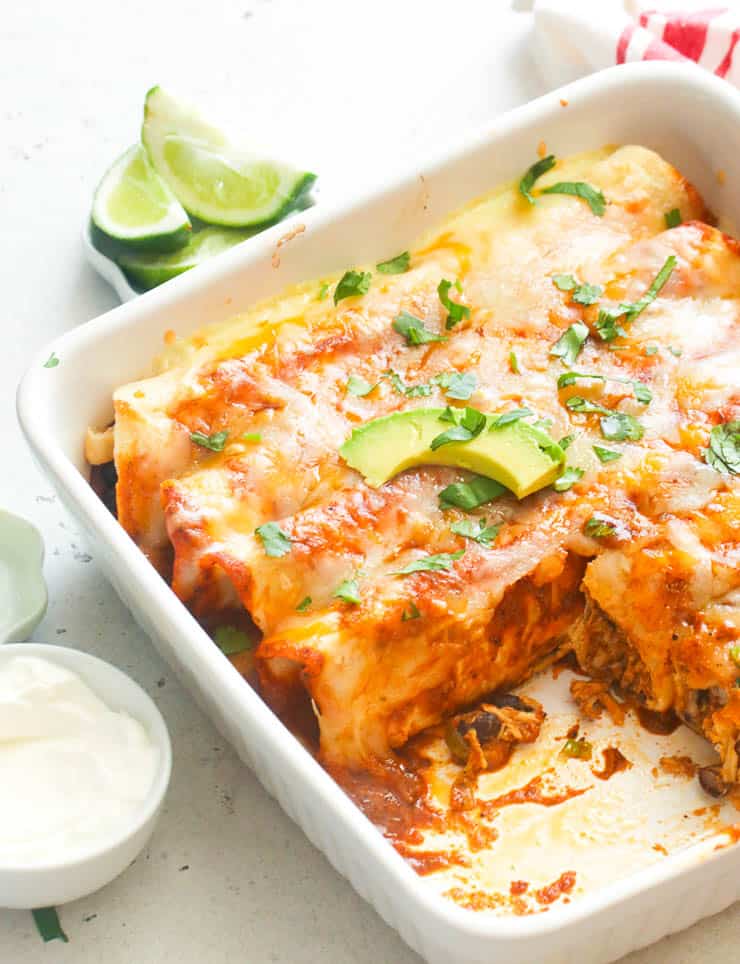 chicken enchiladas on a white baking dish