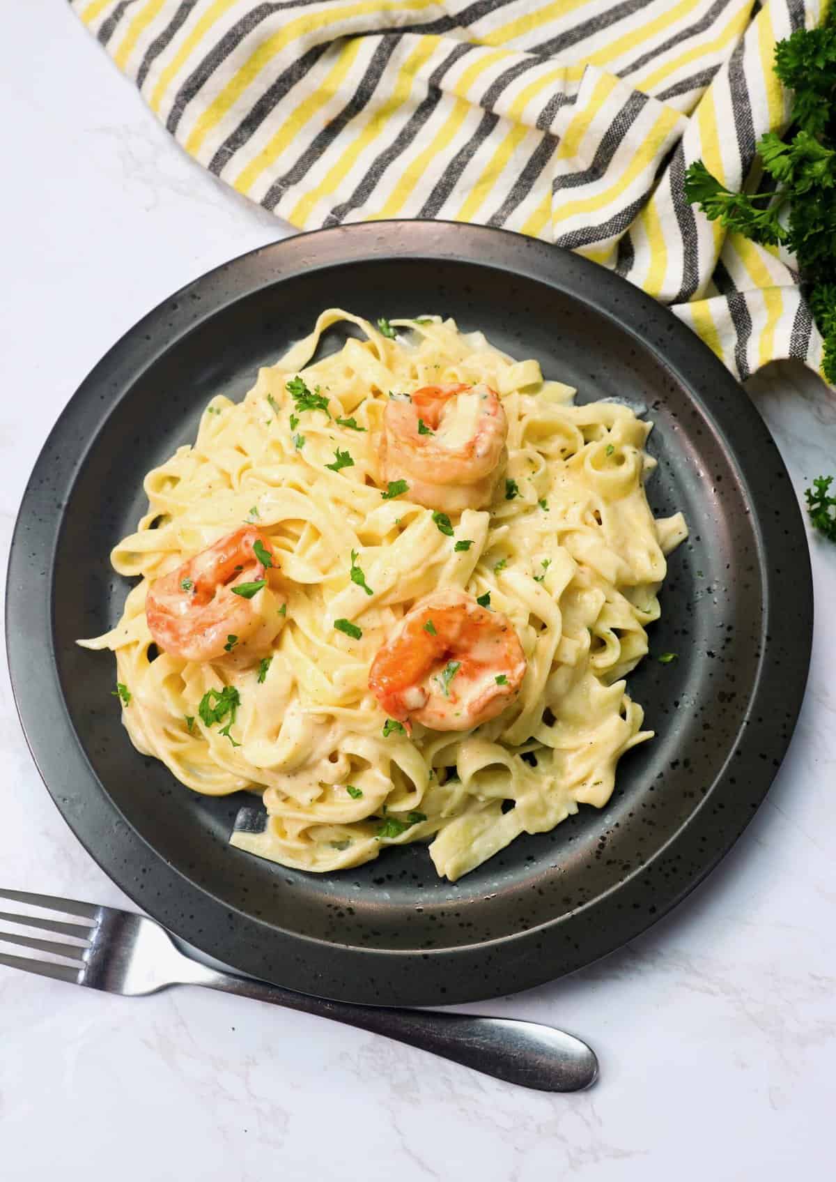 An insanely good plate of shrimp Alfredo pasta