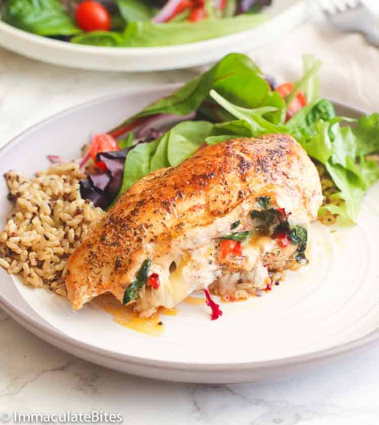 Insanely good Stuffed Chicken breast with spinach and provolone accompanied with a healthy salad and seasoned rice