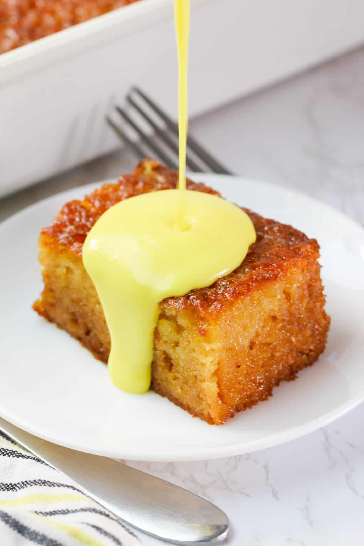 Drizzling decadent soul-satisfying malva pudding cake with cream sauce