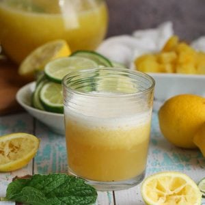 Serving up a glass of Pineapple Lemonade decorated with mint leaves