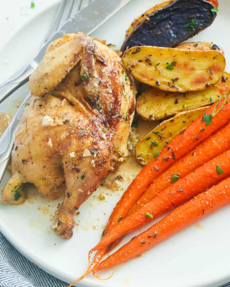 Half a Slice of Roasted Cornish Hen Served with Carrots and Potatoes