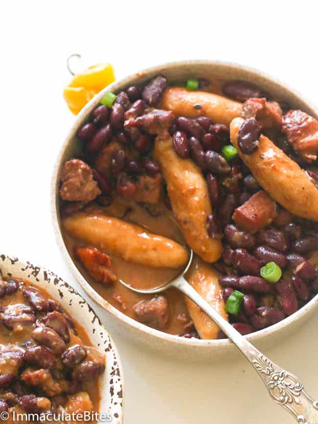 Spooning up a tender spinner (Jamaican dumpling) in a bowl of delicious Jamaican stewed peas