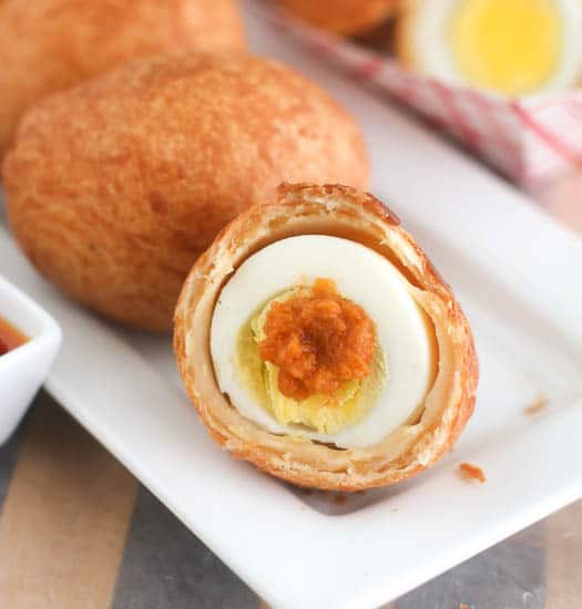 Dabbing some spicy African pepper sauce on an insanely delicious Nigerian scotch egg