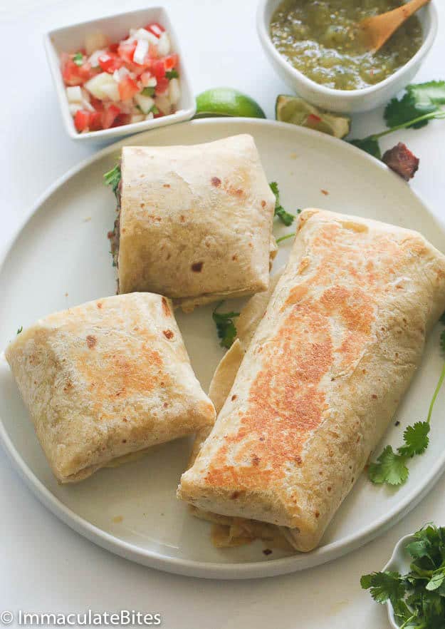 Enjoying a satisfying steak burrito with pico de gallo and salsa verde