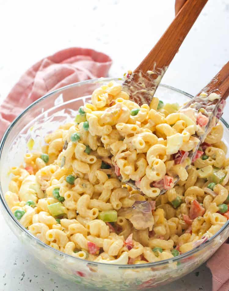 Serving up crazy delicious Tuna Macaroni Salad with wooden spoons