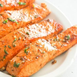 Broiled Salmon on a white platter ready to enjoy