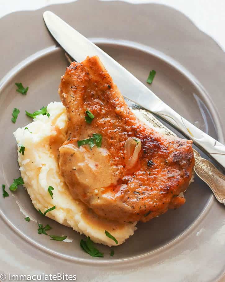 Garlic mashed potatoes topped with an exquisite fried pork chop